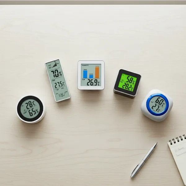A curated selection of various digital hygrometers displayed neatly on a minimalist office desk, emphasizing variety and choice for businesses